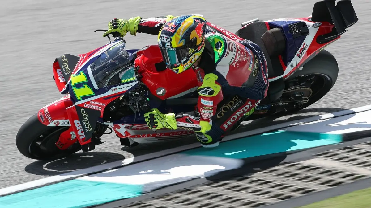 Piloto de MotoGP em alta velocidade durante corrida no circuito de Sepang, Malásia